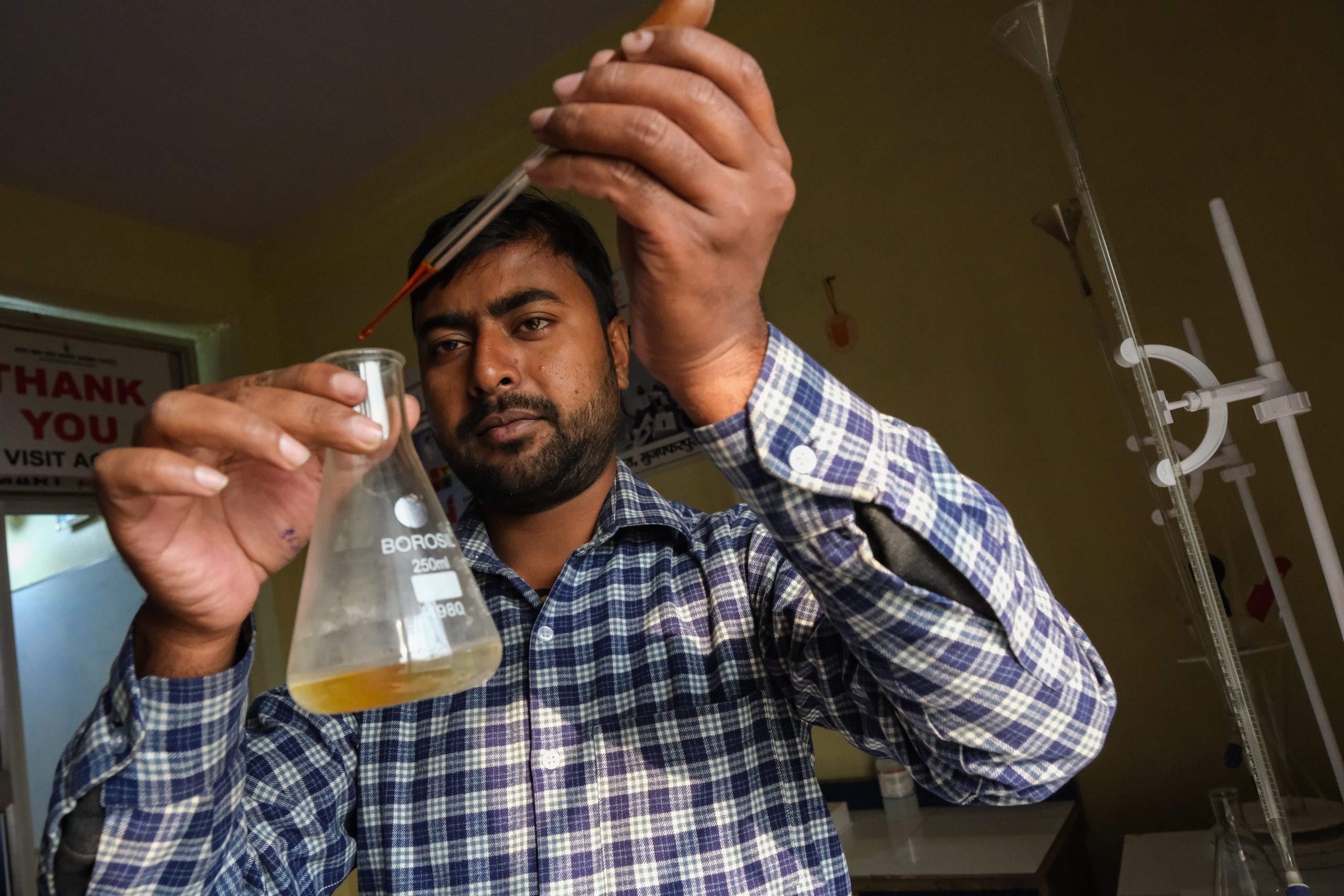 Technician testing rural drinking water in a lab